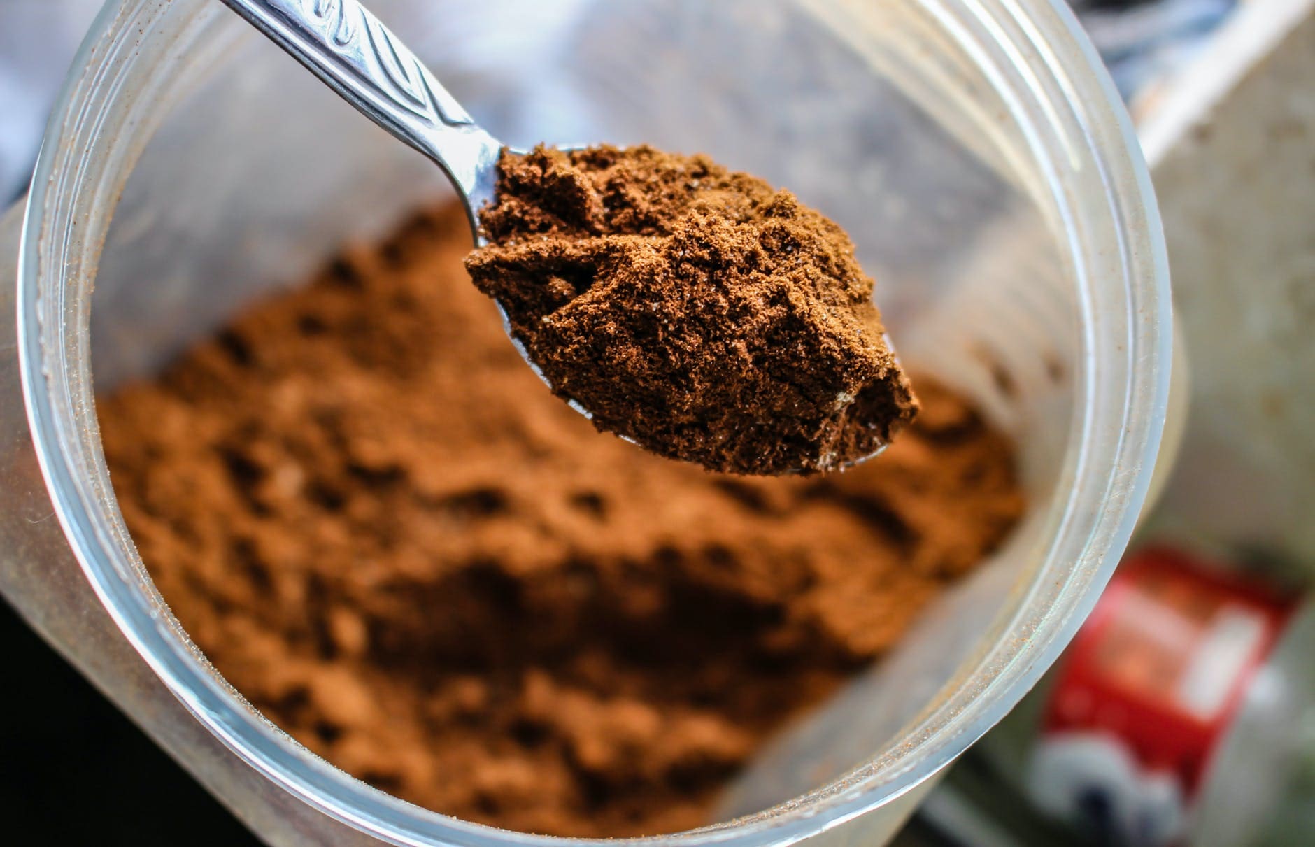 selective photo of brown powder on stainless spoon