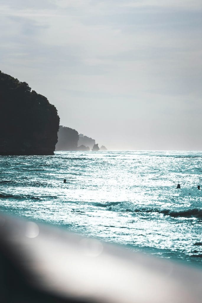 Surfers in Bingin Beach, Bali waiting in the water.