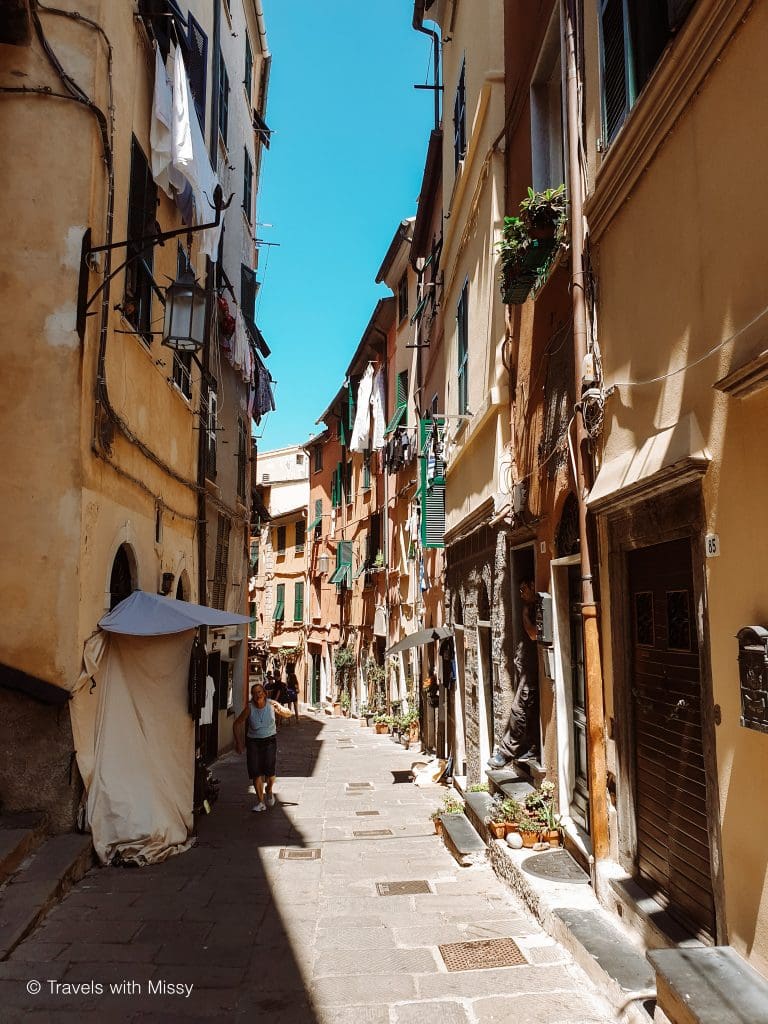 The side streets of Portovenere are colourful, pictured are a clothes line hanging outside a window.