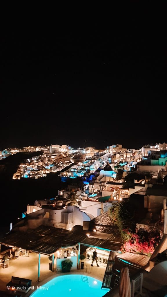 The lights of Oia and pool villas make Santorini at night twinkle.