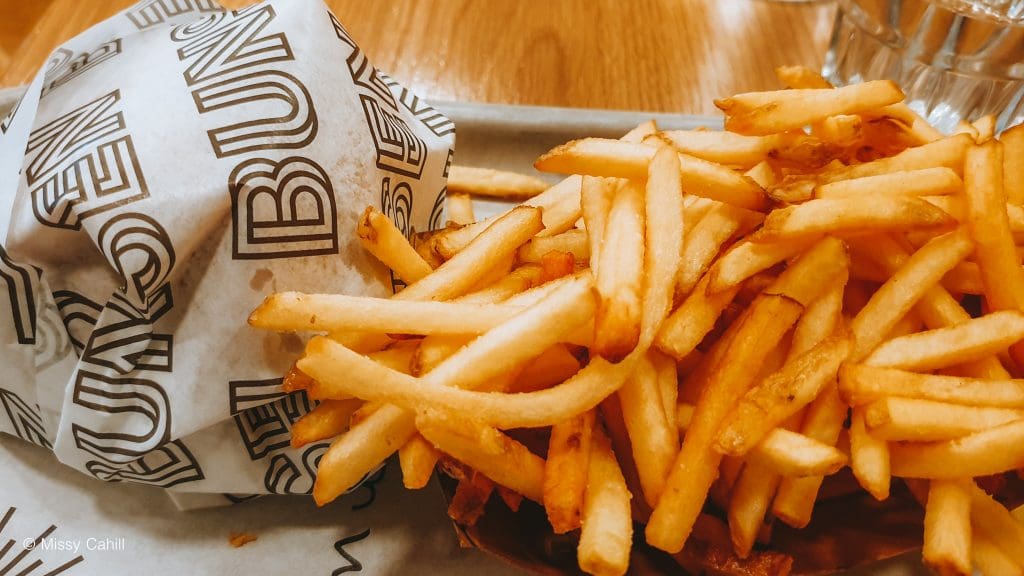 A Bunsen Burger with fries next to it.