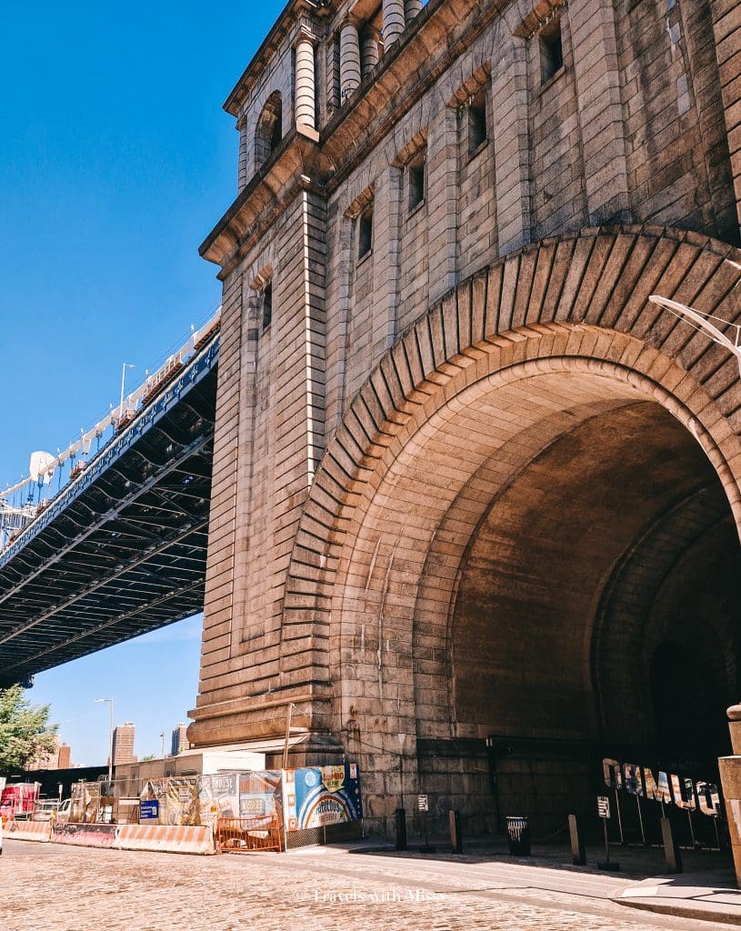 DUMBO Flea Market in Brooklyn is in an archway underneath the Williamsburg Bridge and one of the things to do on a solo trip to New York. 